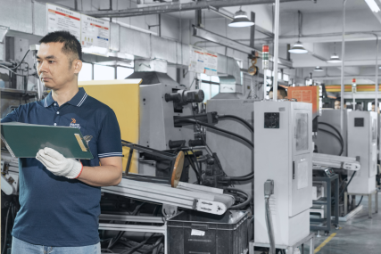 worker operating die casting machine